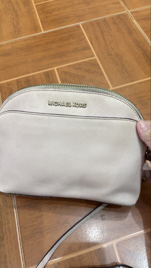 Michael Kors Dome Crossbody Bag (Category: Cross-body Bags) located in Manila. Submitted by calliope777 (Listing ID 1470215475, Image 2). Description: - Brand: Michael Kors - Style: Dome Crossbody Bag - Color: Blush Pink - Material: Saffiano leather with gold-tone hardware - Closure: Zip top - Pockets: Convenient front slip pocket - Strap: Metal chain detail with adjustable long leather strap - Condition: Compact size for daily essentials, with m