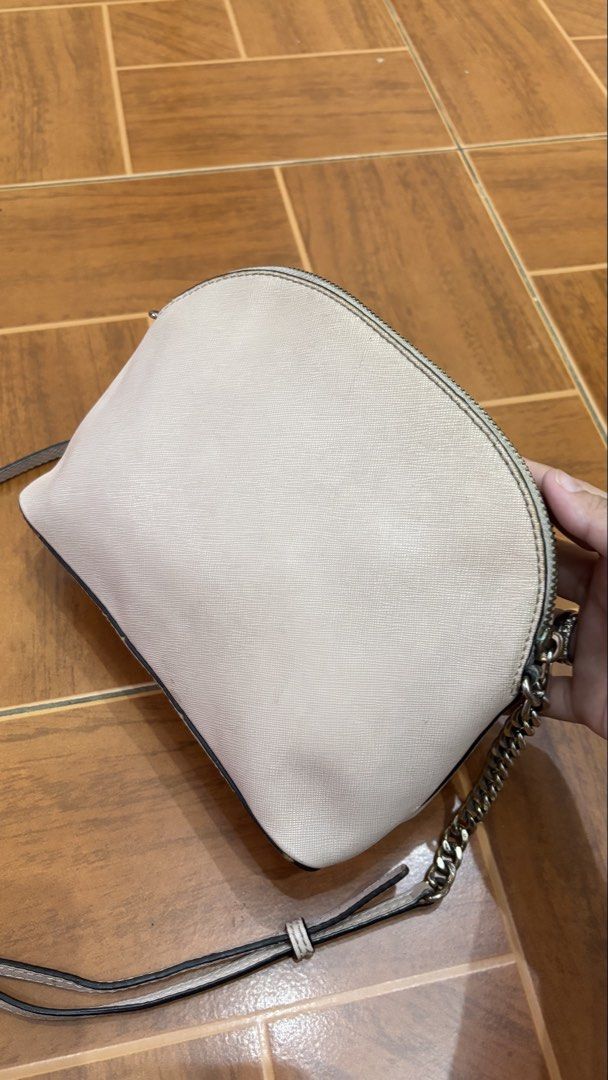Michael Kors Dome Crossbody Bag (Category: Cross-body Bags) located in Manila. Submitted by calliope777 (Listing ID 1470215475, Image 3). Description: - Brand: Michael Kors - Style: Dome Crossbody Bag - Color: Blush Pink - Material: Saffiano leather with gold-tone hardware - Closure: Zip top - Pockets: Convenient front slip pocket - Strap: Metal chain detail with adjustable long leather strap - Condition: Compact size for daily essentials, with m