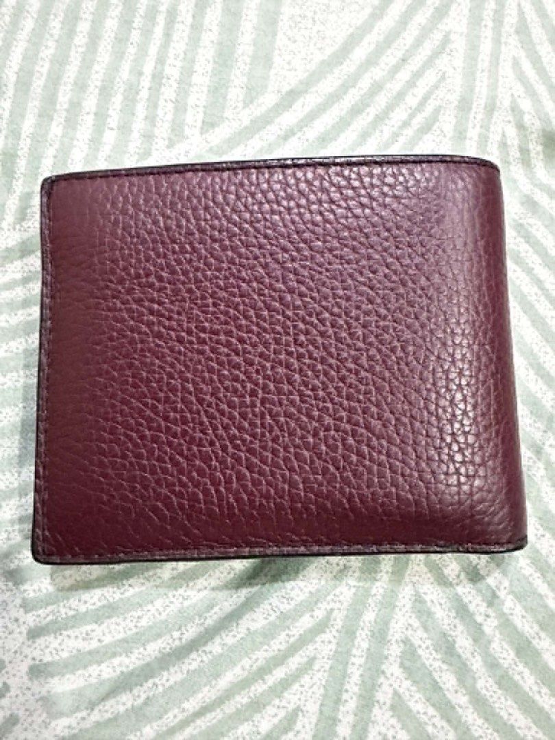 Michael Kors Leather Bifold Wallet Maroon (Category: Wallets & Card Holders) located in Pasig City. Submitted by silentbutterfly (Listing ID 1470344722, Image 1). Description: ‼️Authentic Michael Kors bifold wallet - Premium maroon pebbled leather material - Multiple card slots on the upper section - Includes a removable matching leather card case flap with silver foil embossed logo - Clean interior lining and compact design 📝 Reason for Selling