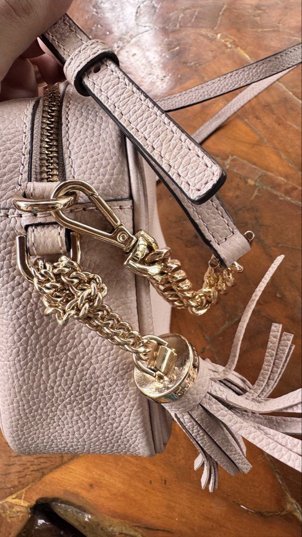 Michael Kors Leather Crossbody Bag (Category: Cross-body Bags) located in Tagbilaran City. Submitted by Bunnybebu (Listing ID 1470295527, Image 2). Description: - Brand: Michael Kors - Material: Pebbled leather in light pink - Hardware: Gold-tone with chain accents and matching leather tassel - Strap: Includes adjustable leather shoulder strap - Interior: MK logo fabric lining with slip and zipper pockets - Condition: Good, with a minor blue ink 