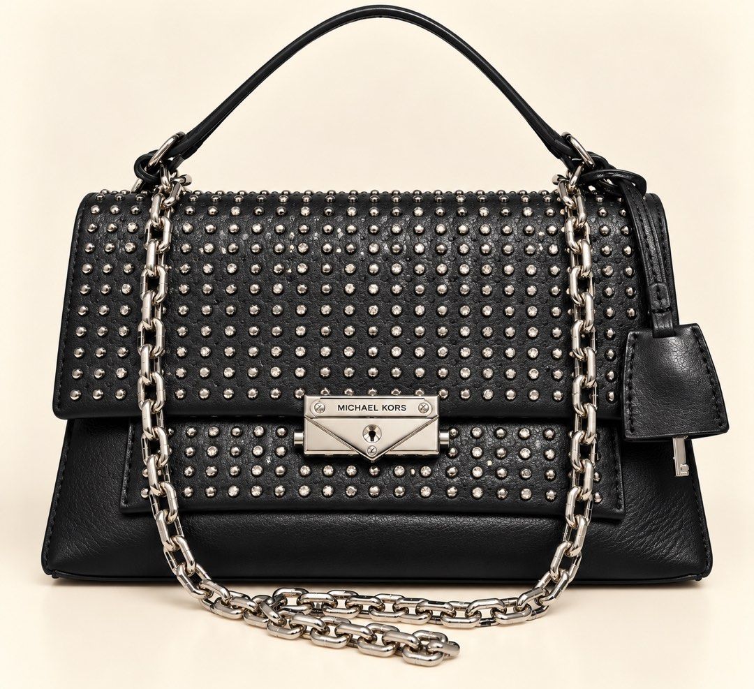 Michael Kors Studded Leather Handbag with Chain Strap (Category: Luxury Bags & Wallets) located in Manila. Submitted by happyshopper212 (Listing ID 1470196470, Image 1). Description: - Like new Michael Kors Guaranteed Authentic Inclusions: Bag and dust bag - Material: Black leather with silver studs and crystals - Closure: Front flap with metal clasp - Straps: Chunky silver chain shoulder strap and a top handle - Extras: Matching leather clochett