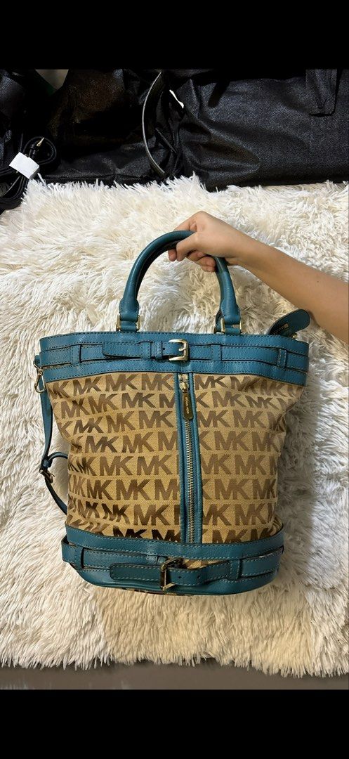 Michael Kors Teal Monogram Canvas Tote Bag (Category: Luxury Bags & Wallets) located in Rizal. Submitted by kianapreloves (Listing ID 1470212568, Image 1). Description: Michael Kors signature monogram print fabric combined with teal leather trim. Gold tone hardware with buckle accents on top and bottom straps. Center front vertical zipper pocket. Double top handles and an adjustable shoulder strap included. Cream monogram fabric lining inside wit