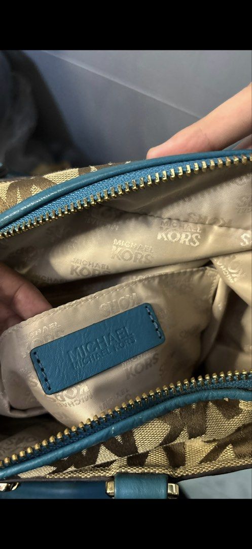 Michael Kors Teal Monogram Canvas Tote Bag (Category: Luxury Bags & Wallets) located in Rizal. Submitted by kianapreloves (Listing ID 1470212568, Image 2). Description: Michael Kors signature monogram print fabric combined with teal leather trim. Gold tone hardware with buckle accents on top and bottom straps. Center front vertical zipper pocket. Double top handles and an adjustable shoulder strap included. Cream monogram fabric lining inside wit