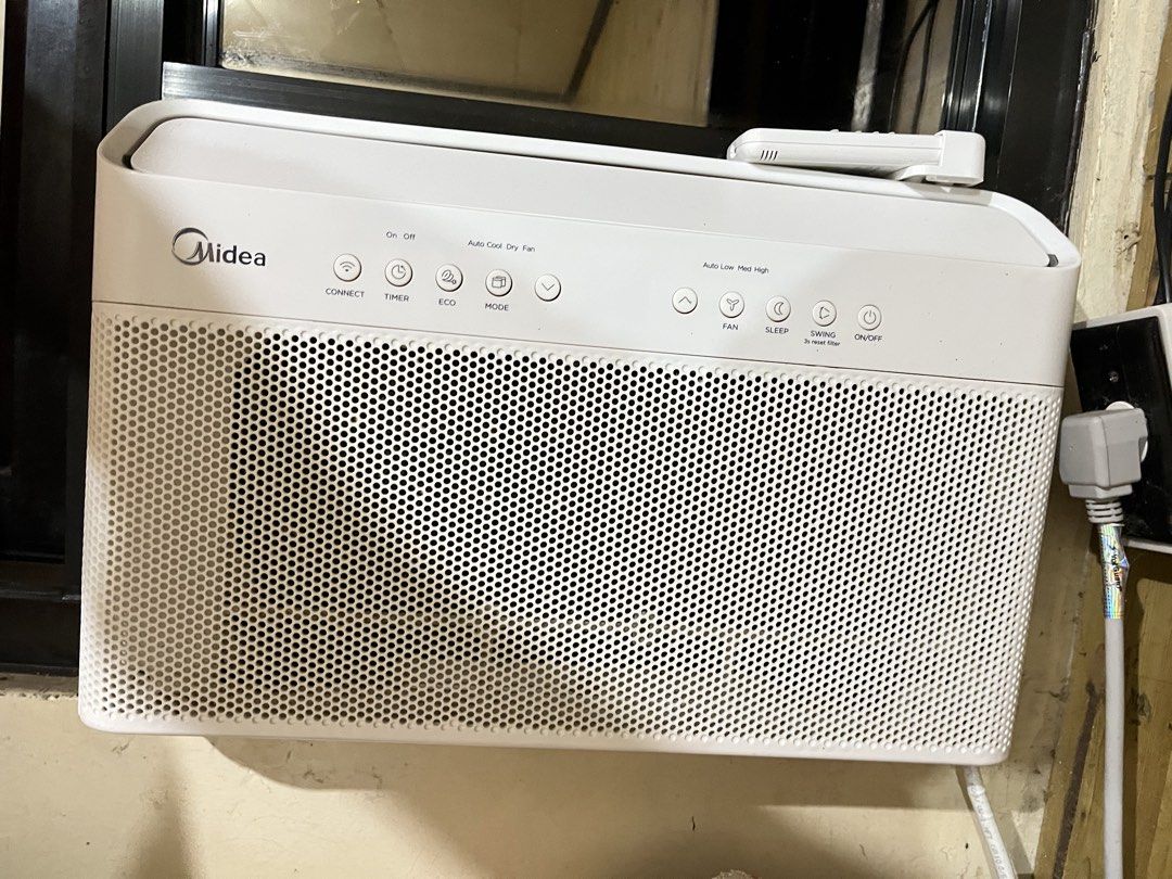 Midea Window Type Air Conditioner with Remote (Category: Air Conditioning and Heating) located in Manila. Submitted by curated.clutter12 (Listing ID 1470151634, Image 1). Description: - Brand: Midea - Type: Window type air conditioner - Color: Clean white with a modern grid design - Controls: Top touch control buttons and digital display remote (modes: Auto, Cool, Dry, Heat) - Extras: Includes matching remote control with a convenient wall mount 