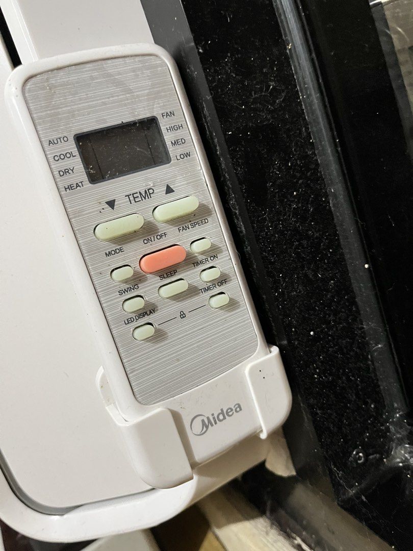 Midea Window Type Air Conditioner with Remote (Category: Air Conditioning and Heating) located in Manila. Submitted by curated.clutter12 (Listing ID 1470151634, Image 2). Description: - Brand: Midea - Type: Window type air conditioner - Color: Clean white with a modern grid design - Controls: Top touch control buttons and digital display remote (modes: Auto, Cool, Dry, Heat) - Extras: Includes matching remote control with a convenient wall mount 