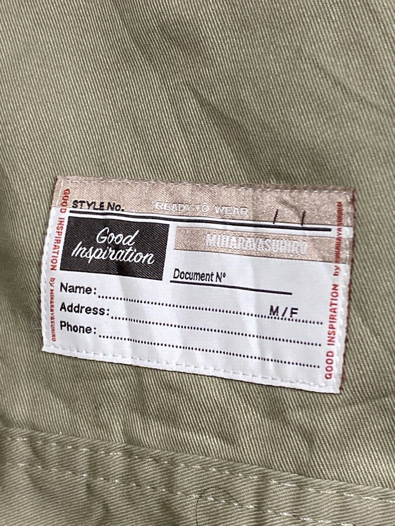 Mihara Yasuhiro Good Inspiration Two-Tone Jacket (Category: Coats, Jackets and Outerwear) located in Caloocan City. Submitted by camarcenin42067 (Listing ID 1470279815, Image 3). Description: - Brand: Mihara Yasuhiro ("Good Inspiration" Collection) - Style: Workwear jacket in khaki body with contrast dark brown long sleeves - Details: Button-up front, multiple utility pockets, and a clear ID slot on the lower front - Accents: Distinctive branded 