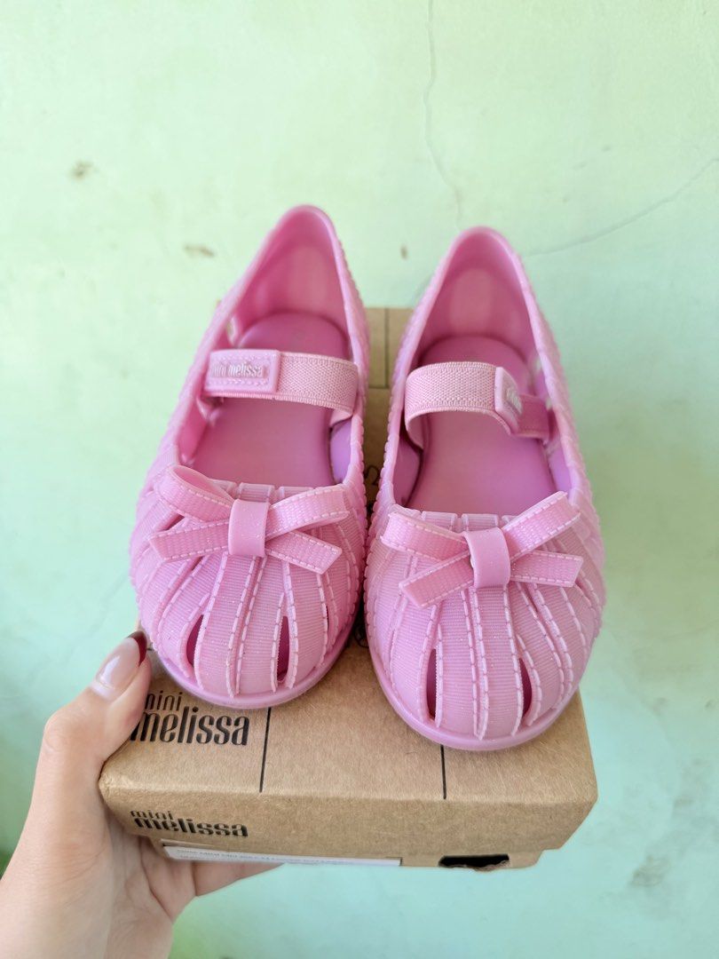 Mini Melissa M Ballerina (Category: Babies & Kids Fashion) located in Tuguegarao City. Submitted by declutteringmommaaa (Listing ID 1470168482, Image 1). Description: - Authentic Mini Melissa toddler jelly flats in a sweet pink shade - Adorable ribbon bow detail on the front toe - Adjustable strap with hook and loop closure for a secure fit - Ideal for everyday outings and special occasions - Includes original brown shoebox.