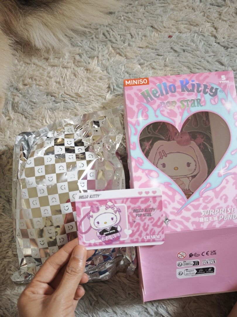 Miniso Hello Kitty Pop Star Blind Box Charm (Category: Character Goods) located in Binan City. Submitted by kimencina (Listing ID 1470159830, Image 2). Description: - Item: Miniso Kitty Pop Star blind box charm - Condition: Box opened, inner foil bag is still sealed - Inclusions: Character collector card included - Packaging: Pink with leopard print details - Shipping: Ready to ship immediately!.