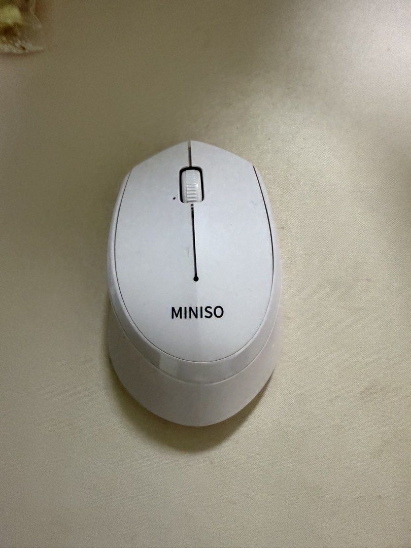 Miniso M516 Wireless Mouse (Category: Mouse & Mousepads) located in Manila. Submitted by elynnethcampo11 (Listing ID 1470268443, Image 1). Description: - Model: Miniso M516 Wireless Mouse - Color: White - Includes USB receiver (as seen in photos) - Features a standard scroll wheel and smooth, clean body design - Battery-operated with an easy-access compartment underneath - Clear branding near the bottom - Perfect and reliable for daily computer t
