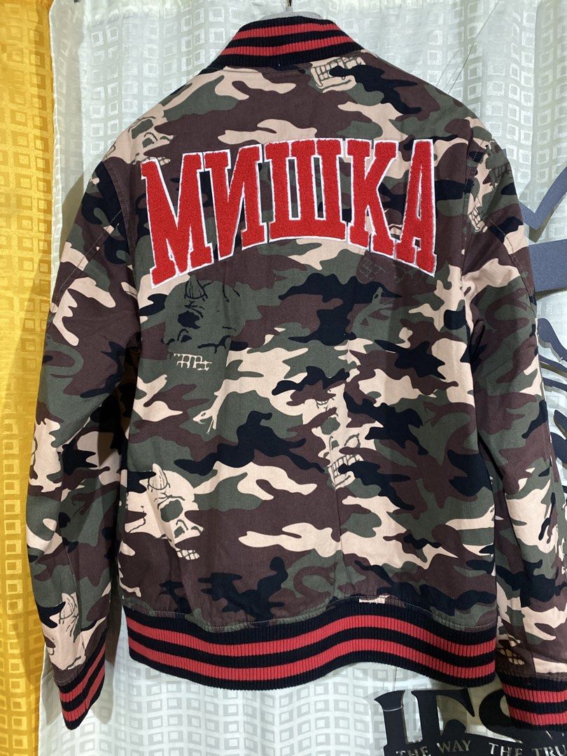 Mishka Keep Watch Camo Varsity Bomber Jacket Medium (Category: Coats, Jackets and Outerwear) located in Caloocan City. Submitted by camarcenin42067 (Listing ID 1470283112, Image 2). Description: - Brand: Mishka (Brooklyn, NY streetwear) - Style: Varsity bomber jacket in camo print - Size: Medium - Details: Iconic embroidered Keep Watch eyeball patch on chest, large Mishka text embroidery on back shoulders - Interior: Warm quilted black lining - C