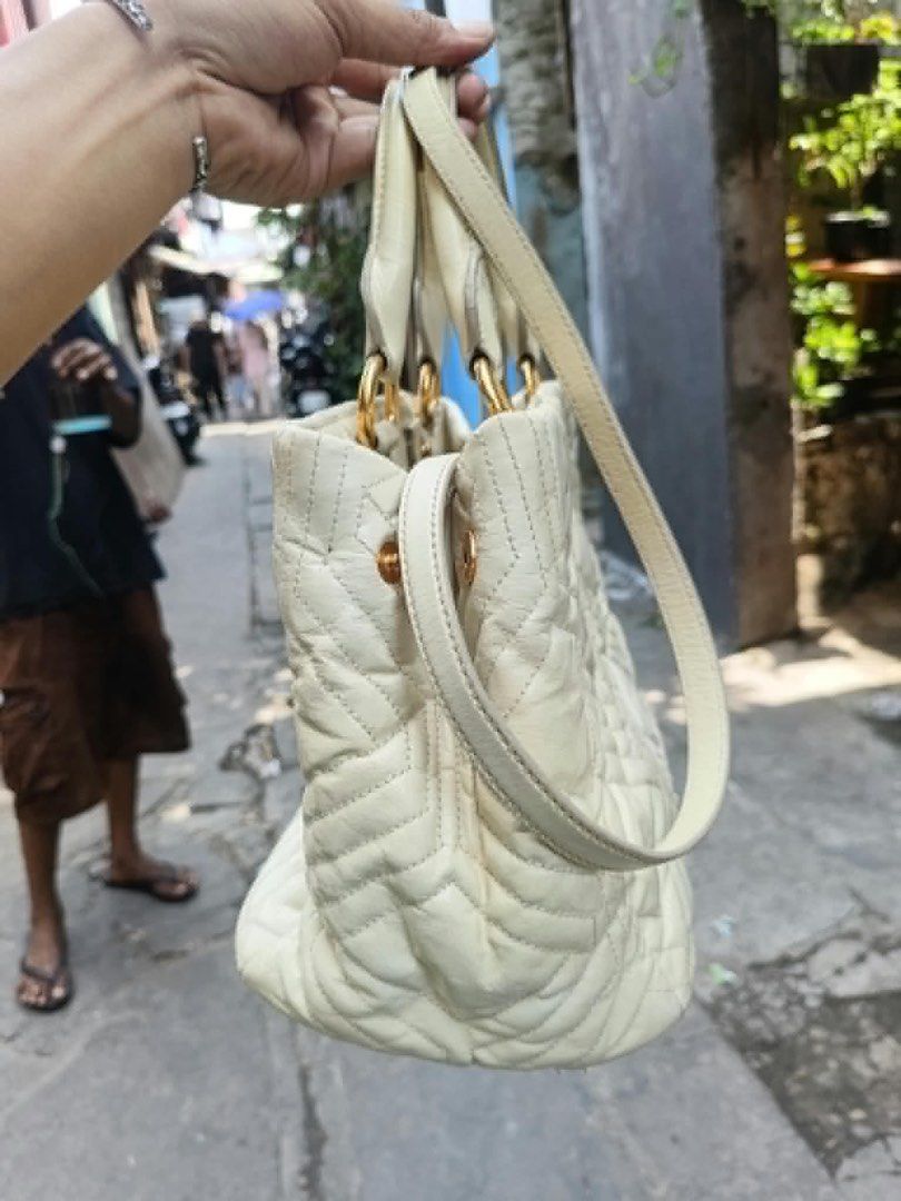 Miu Miu Quilted Leather Tote Bag (Category: Luxury Bags & Wallets) located in Cainta. Submitted by riszizlux (Listing ID 1470234413, Image 3). Description: - Brand: Miu Miu - Material: Premium cream leather with quilted geometric pattern - Hardware: Gold-tone with front branding - Straps: Dual top handles + shoulder strap included - Features: Adjustable side snap buttons to change bag shape - Interior: Roomy and spacious for daily essentials - Co