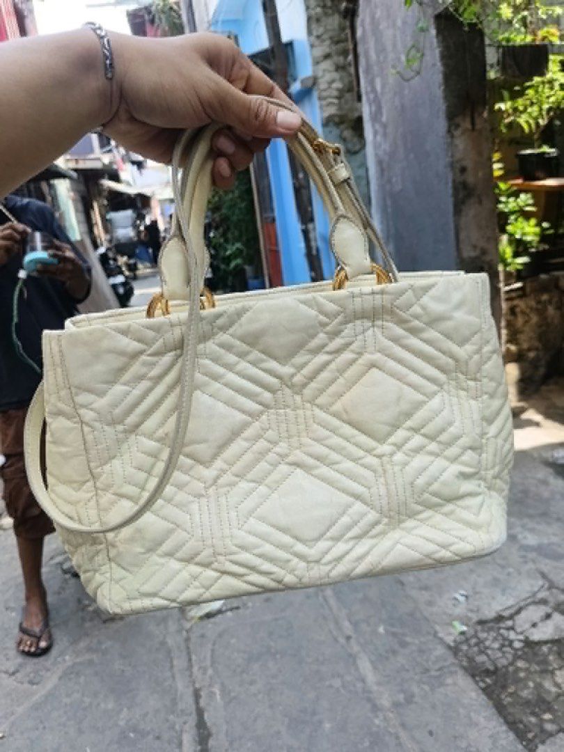 Miu Miu Quilted Leather Tote Bag (Category: Luxury Bags & Wallets) located in Cainta. Submitted by riszizlux (Listing ID 1470234413, Image 2). Description: - Brand: Miu Miu - Material: Premium cream leather with quilted geometric pattern - Hardware: Gold-tone with front branding - Straps: Dual top handles + shoulder strap included - Features: Adjustable side snap buttons to change bag shape - Interior: Roomy and spacious for daily essentials - Co
