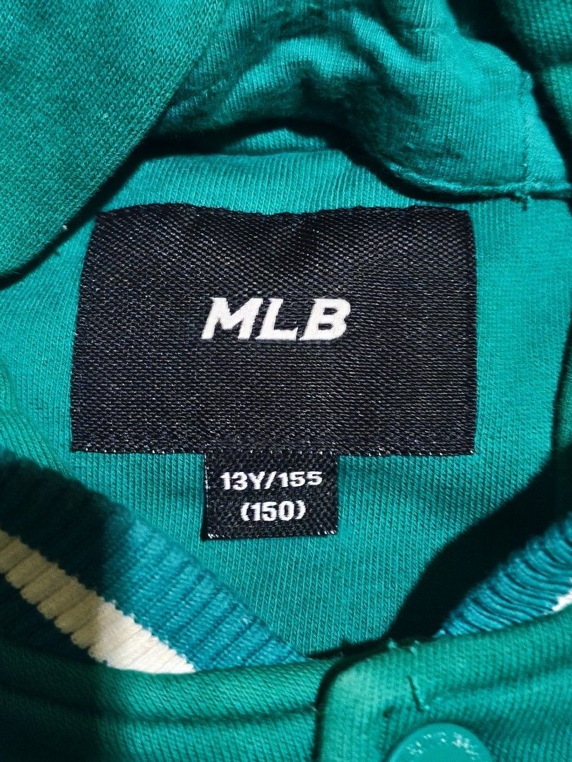 MLB Boston Red Sox Hooded Varsity Jacket 13Y/155 (Category: Babies & Kids Fashion) located in Cebu City. Submitted by bimsai (Listing ID 1470282565, Image 2). Description: 19.5 x 22 - Authentic MLB Boston Red Sox varsity jacket in green and white - Features a cozy hood and quilted green inner lining - Snap-button front closure with striped ribbed cuffs and hem - White faux leather sleeves with a cool Boston Fenway Park patch on the right arm - Si