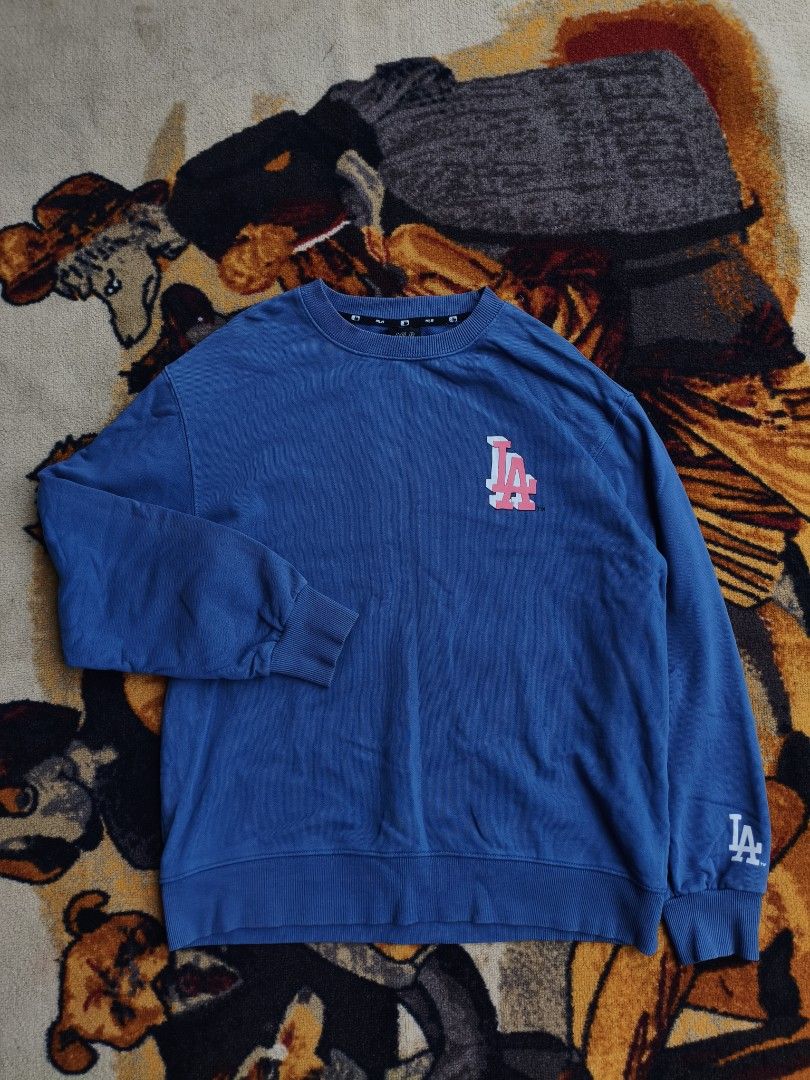MLB Los Angeles Dodgers Blue Sweatshirt (Category: Coats, Jackets and Outerwear) located in Davao. Submitted by simonandre53791 (Listing ID 1470252968, Image 3). Description: - Authentic blue MLB Los Angeles Dodgers sweatshirt - Eye-catching pink and white LA graphics on front, sleeve, and back - Features stylish 'MLB LIKE DODGERS' lettering - Comfortable ribbed collar, cuffs, and hem - Comes with original MLB neck tag attached.