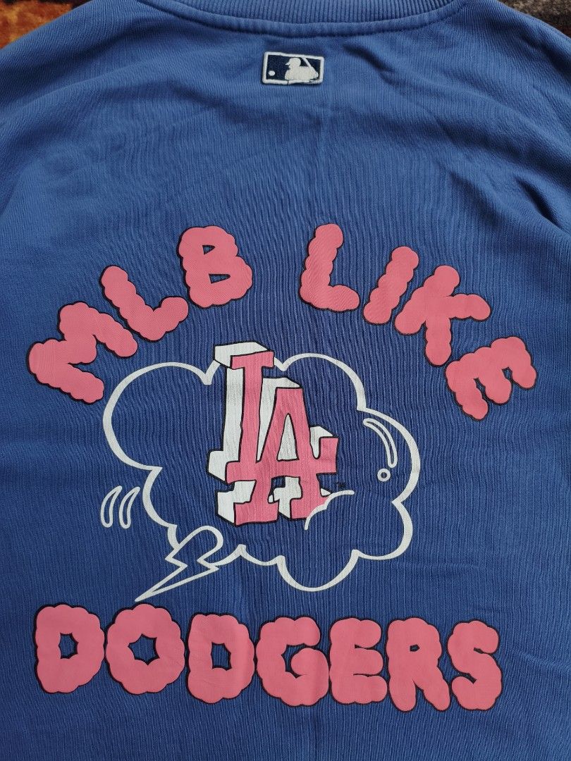 MLB Los Angeles Dodgers Blue Sweatshirt (Category: Coats, Jackets and Outerwear) located in Davao. Submitted by simonandre53791 (Listing ID 1470252968, Image 2). Description: - Authentic blue MLB Los Angeles Dodgers sweatshirt - Eye-catching pink and white LA graphics on front, sleeve, and back - Features stylish 'MLB LIKE DODGERS' lettering - Comfortable ribbed collar, cuffs, and hem - Comes with original MLB neck tag attached.