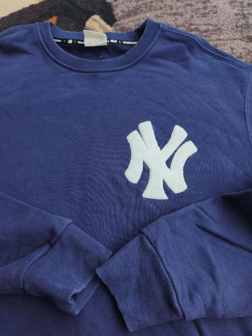 MLB New York Yankees Blue Sweatshirt (Category: Coats, Jackets and Outerwear) located in Davao. Submitted by simonandre53791 (Listing ID 1470253030, Image 2). Description: - Authentic MLB blue sweatshirt with large embroidered New York Yankees chest logo - Cozy soft fleece interior lining for ultimate warmth and comfort - Ribbed cuffs and hem for a snug, secure fit - Features stylish branded tape along the inner neckline - Wash care tag attached;