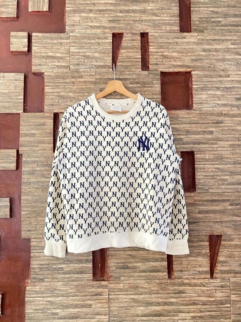 MLB New York Yankees Monogram Sweatshirt Off White (Category: Coats, Jackets and Outerwear) located in Alegria. Submitted by happypenguin-d20d (Listing ID 1470212211, Image 1). Description: - Design: All-over NY Yankees monogram print with solid navy embroidered chest logo - Fit & Comfort: Thick material, comfortable fit, with ribbed crewneck, cuffs, and hem - Style: Casual streetwear, ideal for cooler weather - Color: Off-white and navy blue.