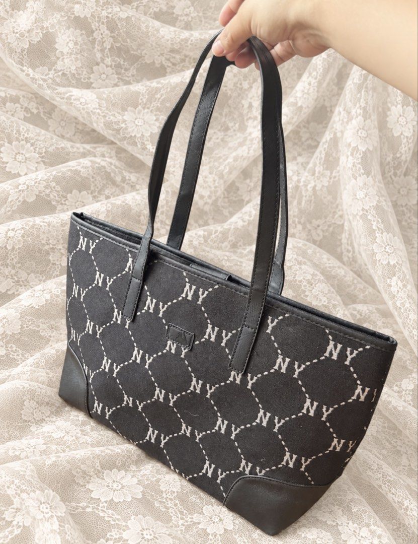MLB New York Yankees Monogram Tote Bag (Category: Tote Bags) located in Manila. Submitted by calliope777 (Listing ID 1470214362, Image 2). Description: - Brand: MLB (New York Yankees) - Color: Classic Black with all-over NY monogram pattern - Includes: Matching NY logo keychain charm - Features: Dual shoulder straps, structured base, and magnetic top snap closure - Interior: Secure zipper compartment, slip pockets, and official MLB brand label - 