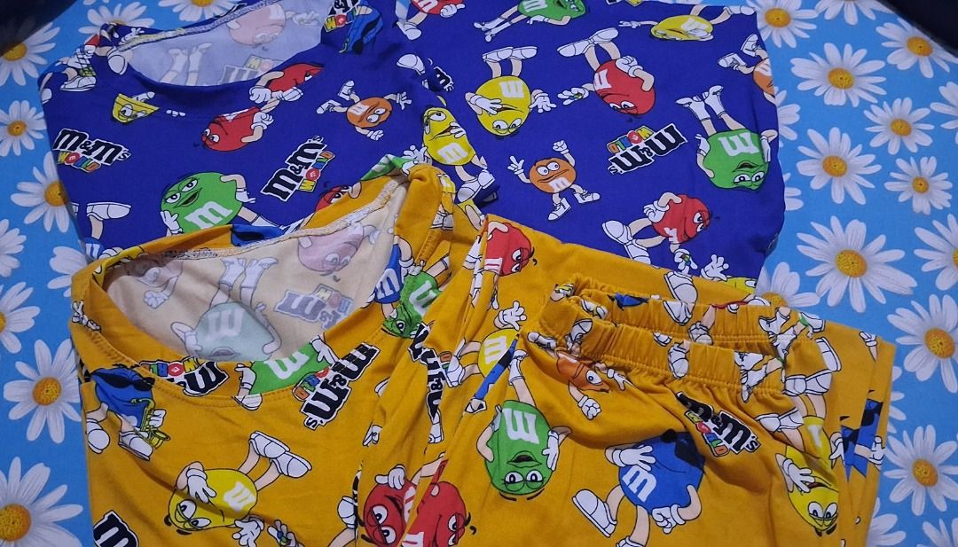 M&M's Character Print Pajama Set Two Colors Available (Category: Undergarments & Loungewear) located in Manila. Submitted by katkween23 (Listing ID 1470172696, Image 1). Description: - Fun M&M character print lounge sets - Includes short sleeve top and matching bottoms - Soft and cozy fabric with all-over cartoon candy graphics - Perfect for sleeping or lazy days at home - Available in 2 vibrant colors: Bright Blue and Mustard Yellow - Buy one or
