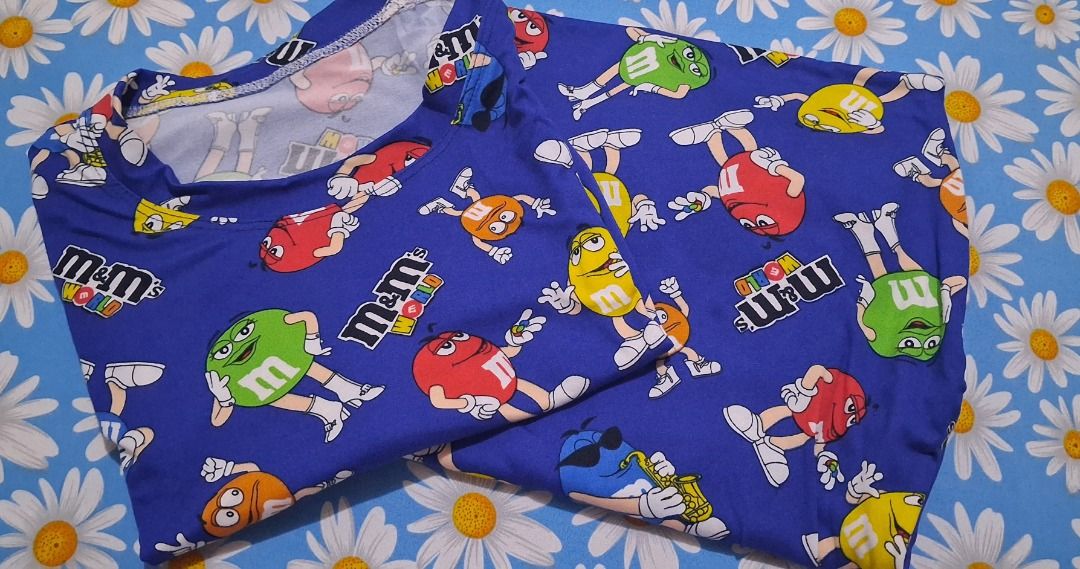 M&M's Character Print Pajama Set Two Colors Available (Category: Undergarments & Loungewear) located in Manila. Submitted by katkween23 (Listing ID 1470172696, Image 2). Description: - Fun M&M character print lounge sets - Includes short sleeve top and matching bottoms - Soft and cozy fabric with all-over cartoon candy graphics - Perfect for sleeping or lazy days at home - Available in 2 vibrant colors: Bright Blue and Mustard Yellow - Buy one or