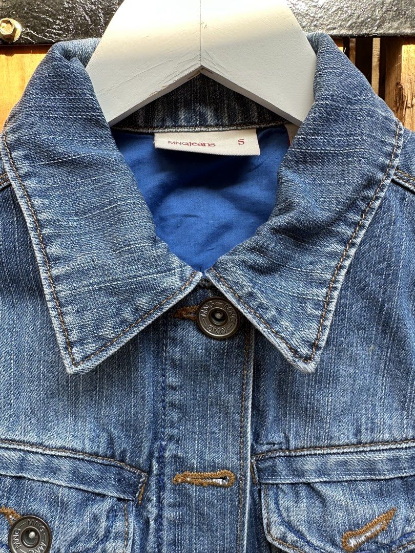 MNG Jeans Blue Denim Jacket Size S (Category: Coats, Jackets and Outerwear) located in Marilao. Submitted by edazh (Listing ID 1470149517, Image 1). Description: - Brand: MNG Jeans - Size: S (fits true to size) - Style: Classic trucker with button closure - Details: Chest flap pockets, contrast stitching, and a bright blue inner lining - Material: Durable cotton denim - Condition: Great for casual everyday layering.