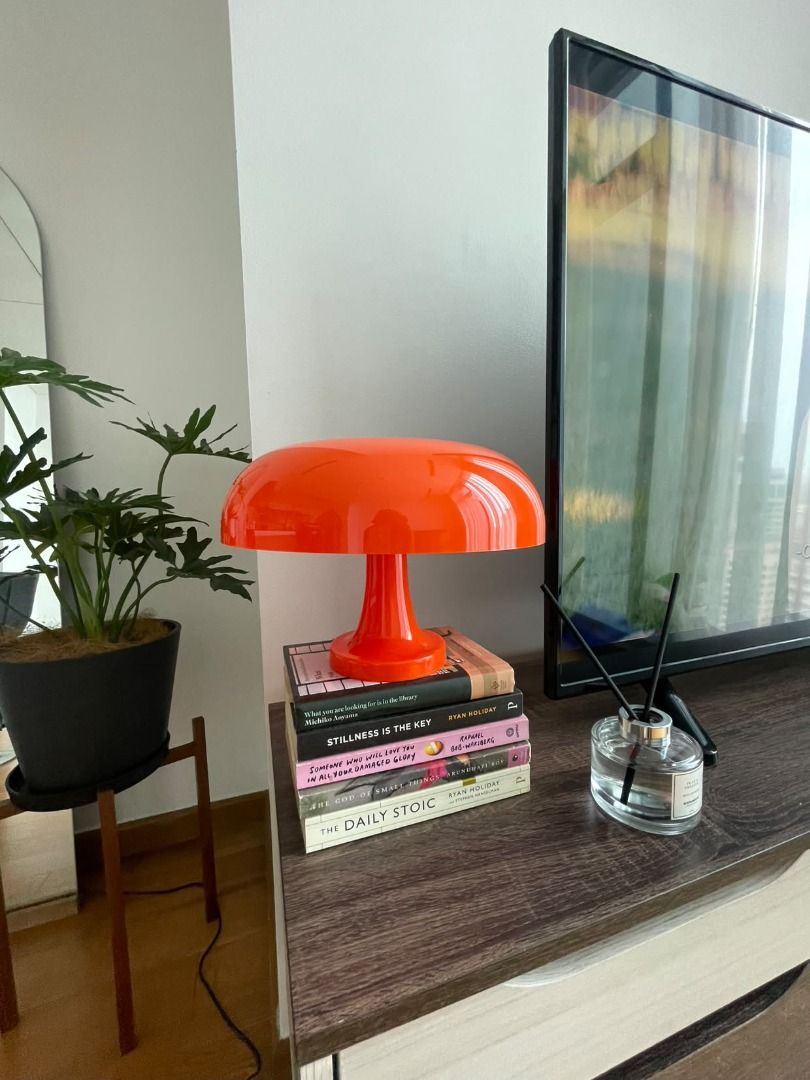 Modern Orange Mushroom Table Lamp (Category: Lighting) located in Pasig City. Submitted by mimosaaas (Listing ID 1470198504, Image 1). Description: - Color & Finish: Bright orange with a glossy finish - Design: Retro mushroom shape, perfect on a stack of books - Lighting: Gives off a cozy warm light - Placement: Ideal for desks or bedside tables - Condition: Works totally fine.