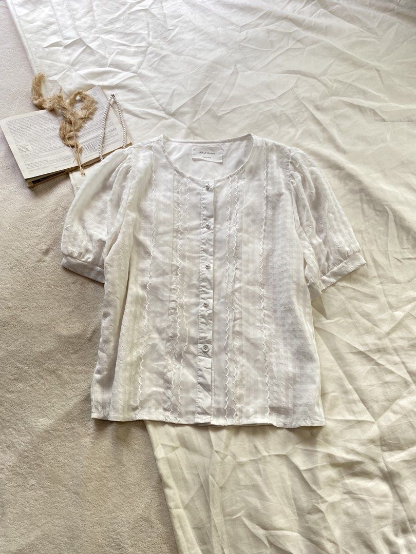 Molly Sugar White Short Sleeve Blouse Button Down Large 39 (Category: Blouses) located in Poro. Submitted by joyceyuu (Listing ID 1470167414, Image 1). Description: - Brand: Molly Sugar - Color: Classic White - Style: Short sleeve button-down blouse with round neckline - Features: Delicate lace trim panels and trendy puffed sleeves - Comfort: Fully lined interior fabric - Versatility: Perfect for both casual weekends and office outfits - Conditio