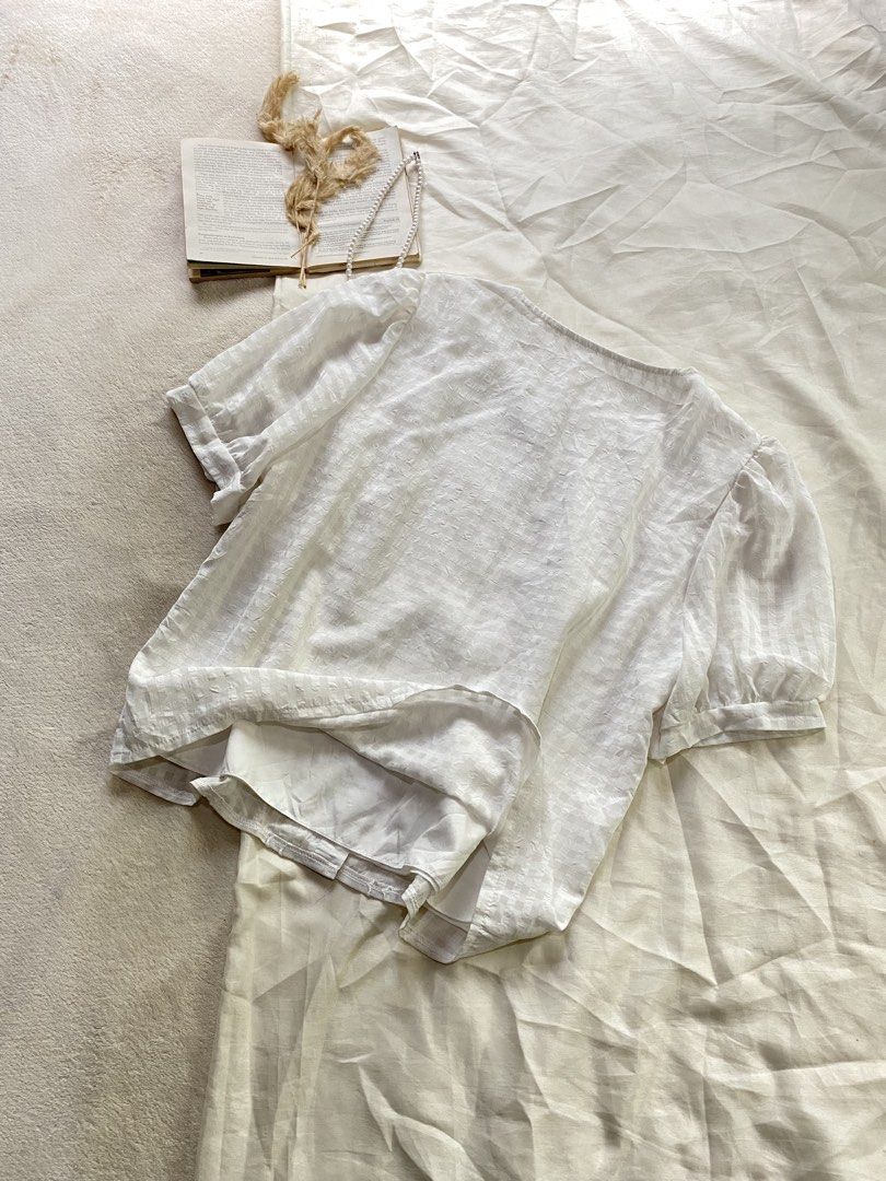 Molly Sugar White Short Sleeve Blouse Button Down Large 39 (Category: Blouses) located in Poro. Submitted by joyceyuu (Listing ID 1470167414, Image 3). Description: - Brand: Molly Sugar - Color: Classic White - Style: Short sleeve button-down blouse with round neckline - Features: Delicate lace trim panels and trendy puffed sleeves - Comfort: Fully lined interior fabric - Versatility: Perfect for both casual weekends and office outfits - Conditio