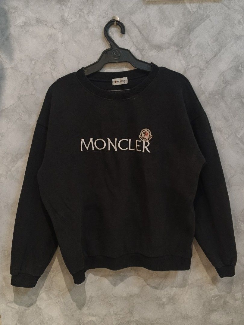 Moncler Embroidered Logo (Category: Coats, Jackets and Outerwear) located in Andop. Submitted by finderskeepersxzz (Listing ID 1470190526, Image 1). Description: S-M womens/ S mens width 20 length 25-26 - Brand: Moncler - Color: Black with large white chest embroidery and logo patch - Material: Heavy cotton, very warm and cozy - Details: Ribbed collar, cuffs, and hem, branded neck tag - Style: Casual streetwear - Note: Pit-to-pit and length measu