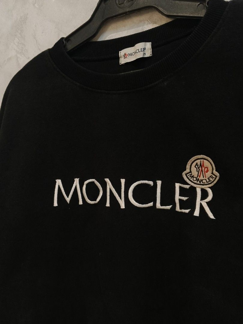 Moncler Embroidered Logo (Category: Coats, Jackets and Outerwear) located in Andop. Submitted by finderskeepersxzz (Listing ID 1470190526, Image 2). Description: S-M womens/ S mens width 20 length 25-26 - Brand: Moncler - Color: Black with large white chest embroidery and logo patch - Material: Heavy cotton, very warm and cozy - Details: Ribbed collar, cuffs, and hem, branded neck tag - Style: Casual streetwear - Note: Pit-to-pit and length measu