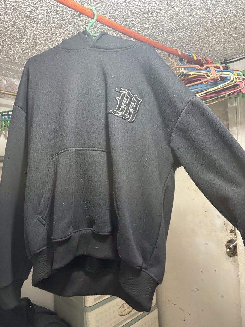 Moneyla black hoodie (Category: Hoodies) located in Manila. Submitted by dav1d__ (Listing ID 1470321912, Image 1). Description: - Color: Solid black - Design: Embroidered gothic lettering on chest and back - Fit: Relaxed fit through arms and torso - Features: Large front pouch pocket, ribbed cuffs and hem - Material: Thick, very warm, and cozy fabric - Condition: Great everyday piece for cooler weather .