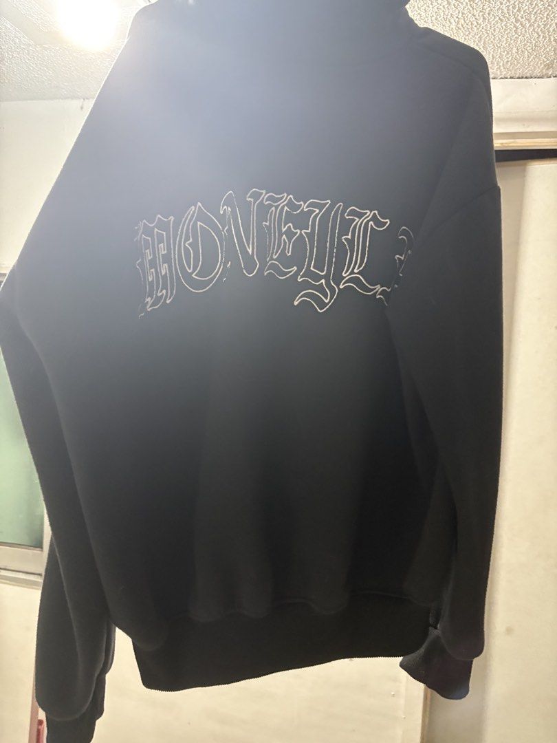 Moneyla black hoodie (Category: Hoodies) located in Manila. Submitted by dav1d__ (Listing ID 1470321912, Image 2). Description: - Color: Solid black - Design: Embroidered gothic lettering on chest and back - Fit: Relaxed fit through arms and torso - Features: Large front pouch pocket, ribbed cuffs and hem - Material: Thick, very warm, and cozy fabric - Condition: Great everyday piece for cooler weather .