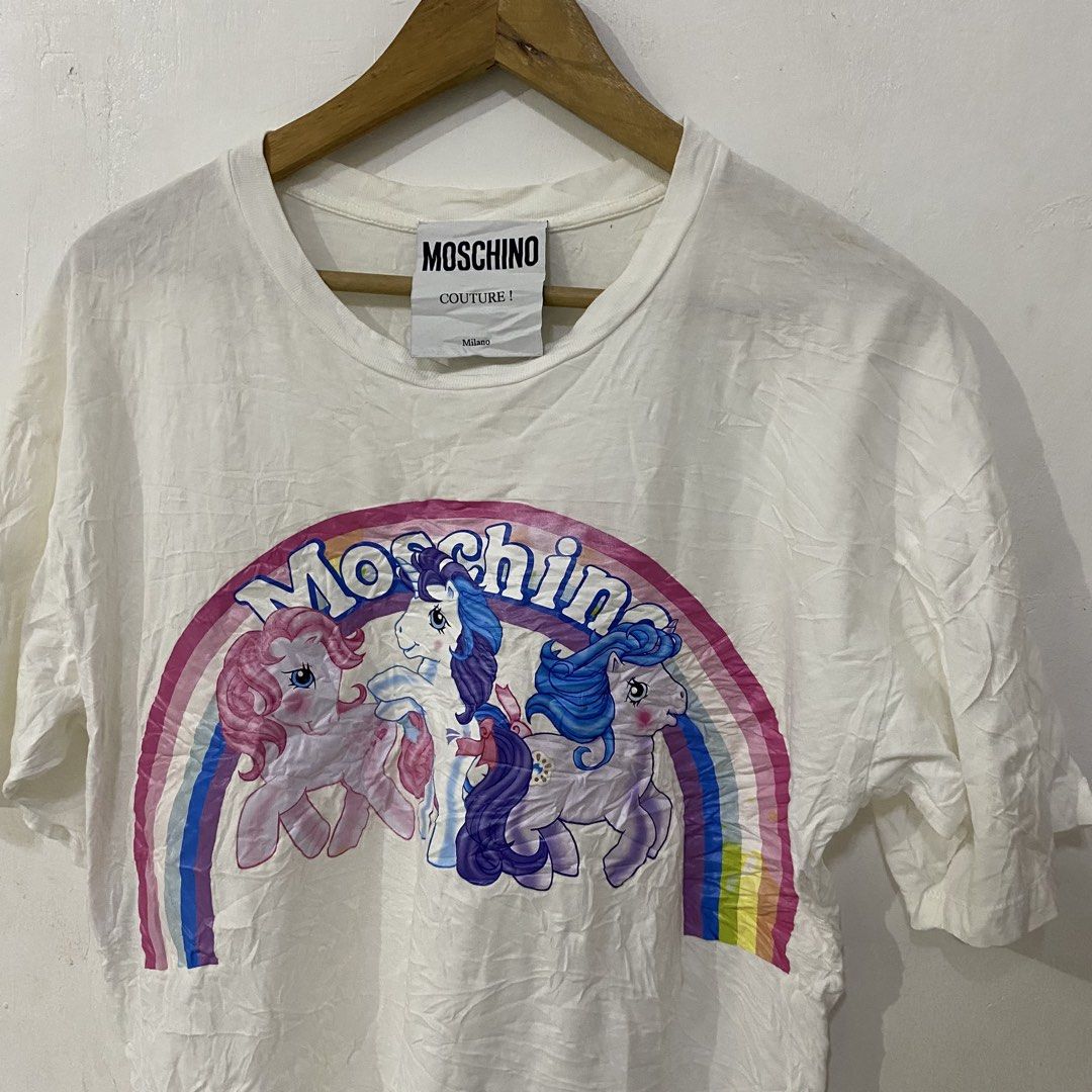 Moschino Unicorn Logo Tshirt (Category: Luxury Apparel) located in Las Pinas. Submitted by declutter_thing69 (Listing ID 1470185882, Image 2). Description: Moschino Unicorn Logo Tshirt Small Good condish width 19 inches length 28 inches shoulder 21 inches sleeve 7.5 inches.