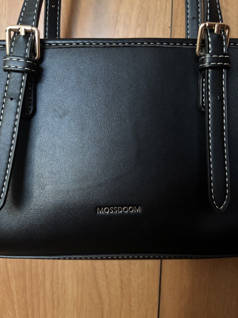 Mossdoom Black Shoulder Bag (Category: Shoulder Bags) located in Cainta. Submitted by missirii (Listing ID 1470216562, Image 3). Description: - Brand: Mossdoom - Color: Classic black with white contrast stitching - Material: Smooth, premium-looking faux leather - Closure: Secure top zip closure - Condition: Like new (only used like less than 20 times).