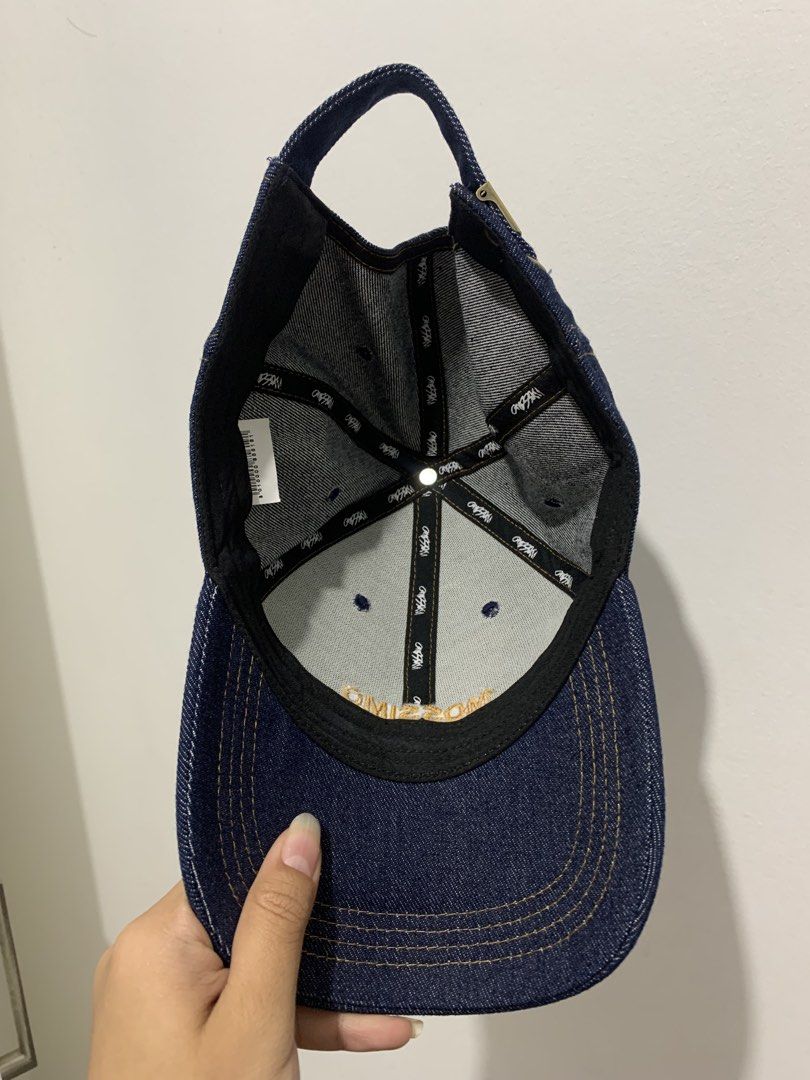 Mossino Dark Blue Denim Baseball Cap (Category: Caps & Hats) located in Manila. Submitted by seasalt.000 (Listing ID 1470160016, Image 2). Description: - Brand: Mossino - Color: Dark blue denim with yellow embroidered logo lettering - Details: Contrast stitching throughout and branded interior seam taping - Closure: Adjustable metal strap at the back - Fit: Standard adult sizing (fits most) - Condition: Clean interior tag with barcode details inc