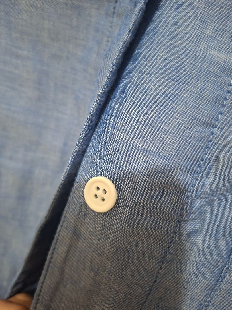 Muji Blue Chambray Button-Up Shirt with Front Pocket (Category: Blouses) located in Paranaque City. Submitted by potatoiceblended (Listing ID 1470179188, Image 3). Description: 22 x 26 inches - Size: XL - Color: Blue chambray - Details: Rounded neckline, half-length sleeves, single chest pocket, white front buttons - Material: Light and very breathable - Condition: Worn a couple of times, retains shape well - Style: Versatile, easy to match with 