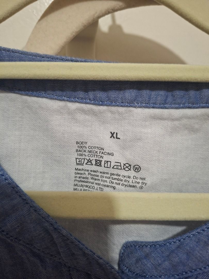 Muji Blue Chambray Button-Up Shirt with Front Pocket (Category: Blouses) located in Paranaque City. Submitted by potatoiceblended (Listing ID 1470179188, Image 2). Description: 22 x 26 inches - Size: XL - Color: Blue chambray - Details: Rounded neckline, half-length sleeves, single chest pocket, white front buttons - Material: Light and very breathable - Condition: Worn a couple of times, retains shape well - Style: Versatile, easy to match with 