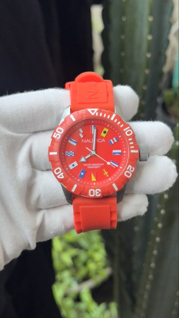 Nautica Red Silicone Strap Dive Watch with Nautical Flags (Category: Men's Watches) located in Manila. Submitted by junjun12356 (Listing ID 1470167657, Image 1). Description: - Authentic Nautica watch in bright red with a matching orange-red silicone strap - Bold dial featuring unique nautical flag hour markers - Rotating bezel with clear white minute markings - Water resistant up to 100M for everyday durability - Clean case and crystal with zero