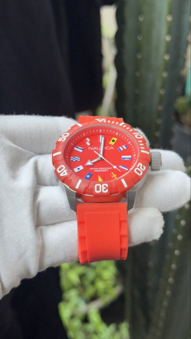 Nautica Red Silicone Strap Dive Watch with Nautical Flags (Category: Men's Watches) located in Manila. Submitted by junjun12356 (Listing ID 1470167657, Image 2). Description: - Authentic Nautica watch in bright red with a matching orange-red silicone strap - Bold dial featuring unique nautical flag hour markers - Rotating bezel with clear white minute markings - Water resistant up to 100M for everyday durability - Clean case and crystal with zero
