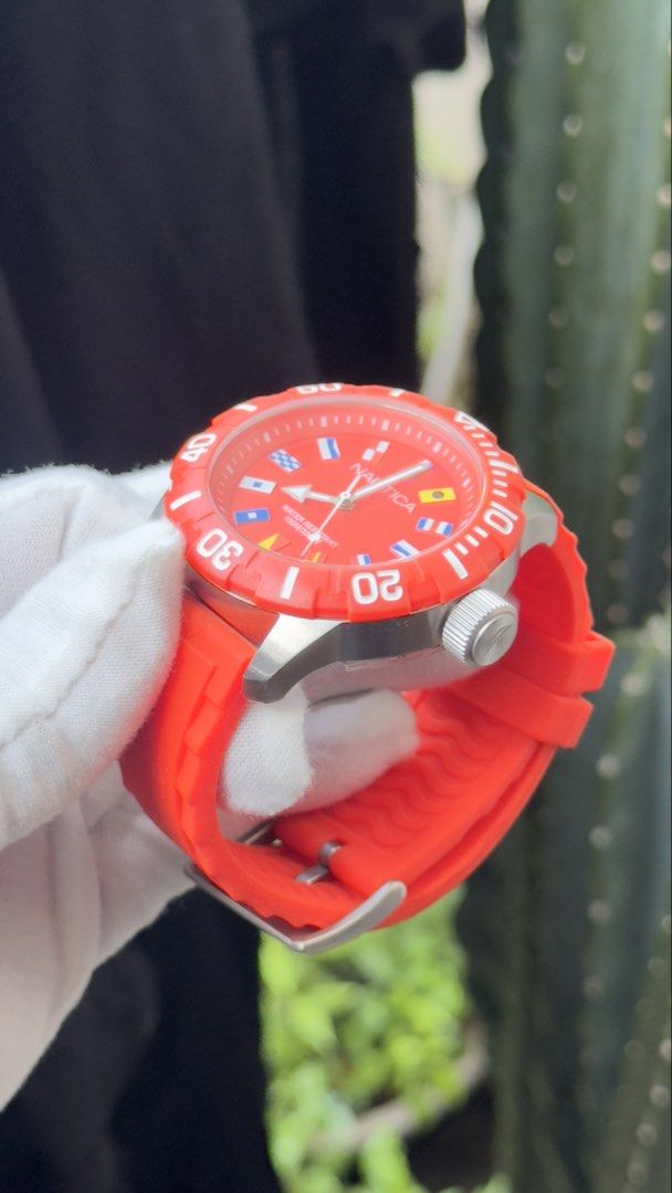 Nautica Red Silicone Strap Dive Watch with Nautical Flags (Category: Men's Watches) located in Manila. Submitted by junjun12356 (Listing ID 1470167657, Image 3). Description: - Authentic Nautica watch in bright red with a matching orange-red silicone strap - Bold dial featuring unique nautical flag hour markers - Rotating bezel with clear white minute markings - Water resistant up to 100M for everyday durability - Clean case and crystal with zero