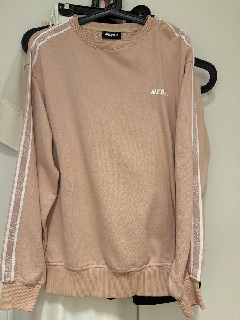 Nerdy pullover (Category: Longsleeves) located in Singapore. Submitted by sl_3715 (Listing ID 1470247799, Image 1). Description: - Brand: NERDY - Item: Pullover / Sweatshirt - Color: Pink with white sleeve taping and chest logo - Size: XS (100% Cotton) - Condition: Excellent pre-loved condition - Features: Soft interior, stylish streetwear aesthetic .