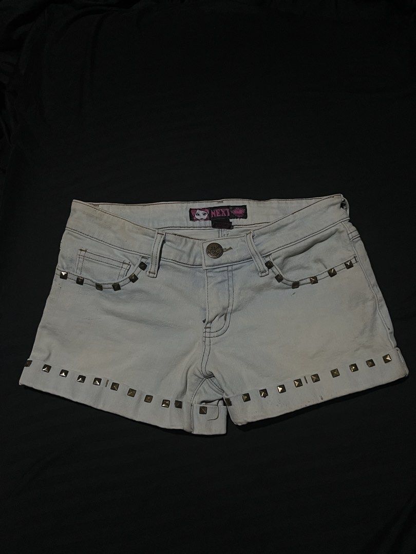NEXT Light Wash Studded Denim Shorts Size M (Category: Shorts) located in Manila. Submitted by y2kcloset_ (Listing ID 1470184716, Image 1). Description: - Brand: NEXT - Size: Medium - Wash: Light wash denim - Fit: Mid-rise with button and zip fly closure - Details: Brass studs on front, back pockets, and cuffs with rolled hems - Style: Y2K, casual festival vibe.