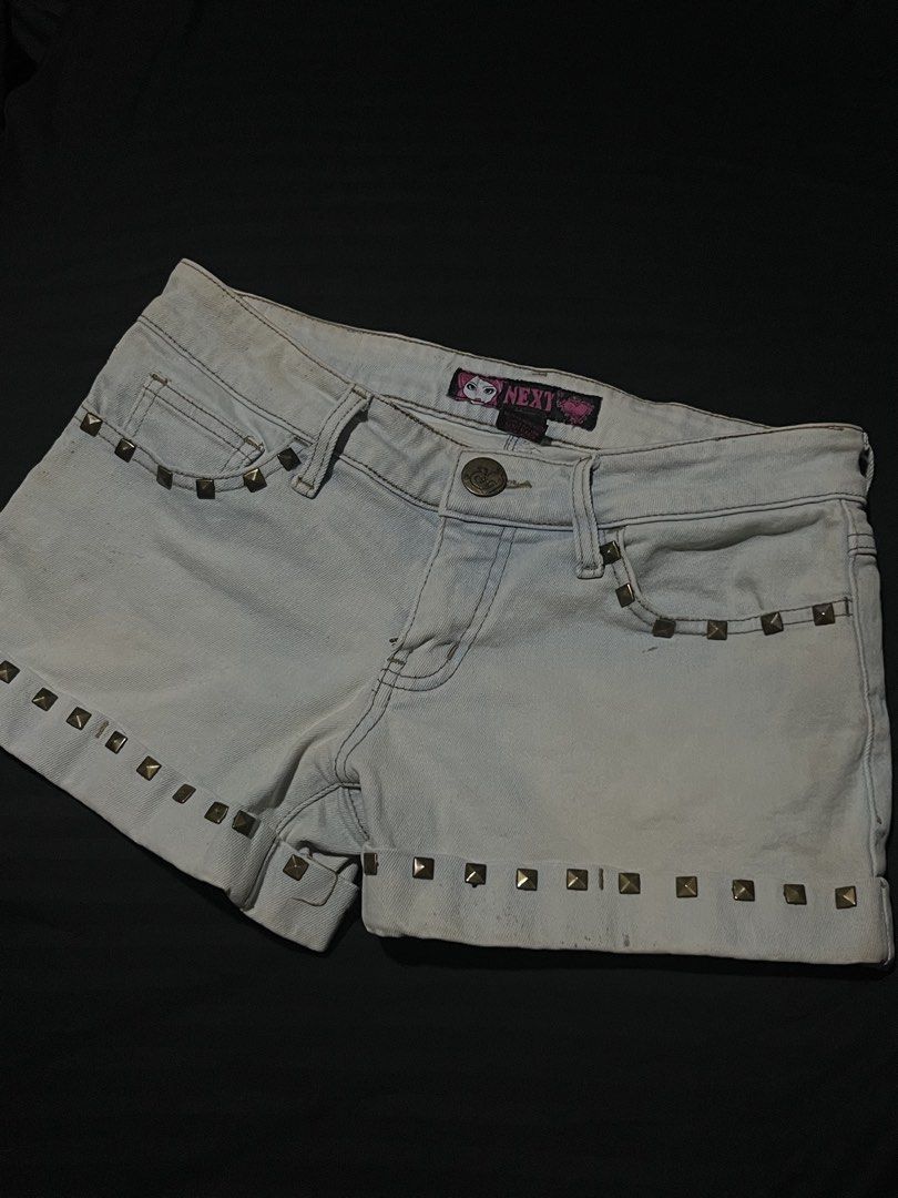 NEXT Light Wash Studded Denim Shorts Size M (Category: Shorts) located in Manila. Submitted by y2kcloset_ (Listing ID 1470184716, Image 2). Description: - Brand: NEXT - Size: Medium - Wash: Light wash denim - Fit: Mid-rise with button and zip fly closure - Details: Brass studs on front, back pockets, and cuffs with rolled hems - Style: Y2K, casual festival vibe.