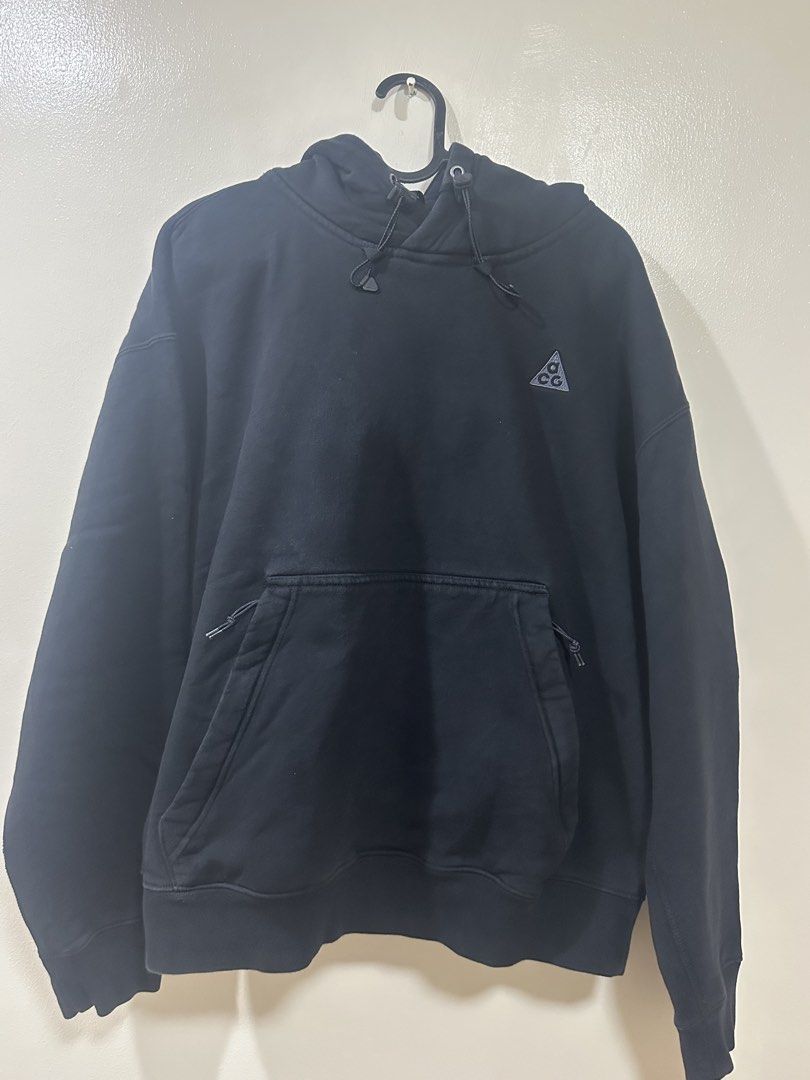 Nike ACG Black Hoodie (Category: Coats, Jackets and Outerwear) located in Manila. Submitted by rarewhale-91927a (Listing ID 1470216001, Image 1). Description: - Authentic Nike ACG heavyweight fleece hoodie in solid black - Warm and cozy, perfect for cold weather and outdoor layering - Trendy boxy fit for a clean, streetwear-ready look - Practical zippered kangaroo pocket to keep your essentials secure - Adjustable drawstrings with premium branded