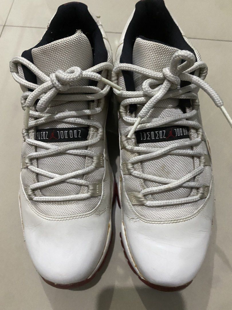 Nike Air Jordan 11 Retro Low Cherry (Category: Sneakers) located in Pasig City. Submitted by alhers.417 (Listing ID 1470256910, Image 3). Description: For sale Jordan 11 low White and red Air Jordan 11 lows. Patent leather mudguard paired with mesh uppers. Red translucent outsoles with herringbone traction pods. Black inner lining and heel tabs with red Jumpman branding. Number 23 on the heels. Regular lace-up closure. Noticeable creasing on leat