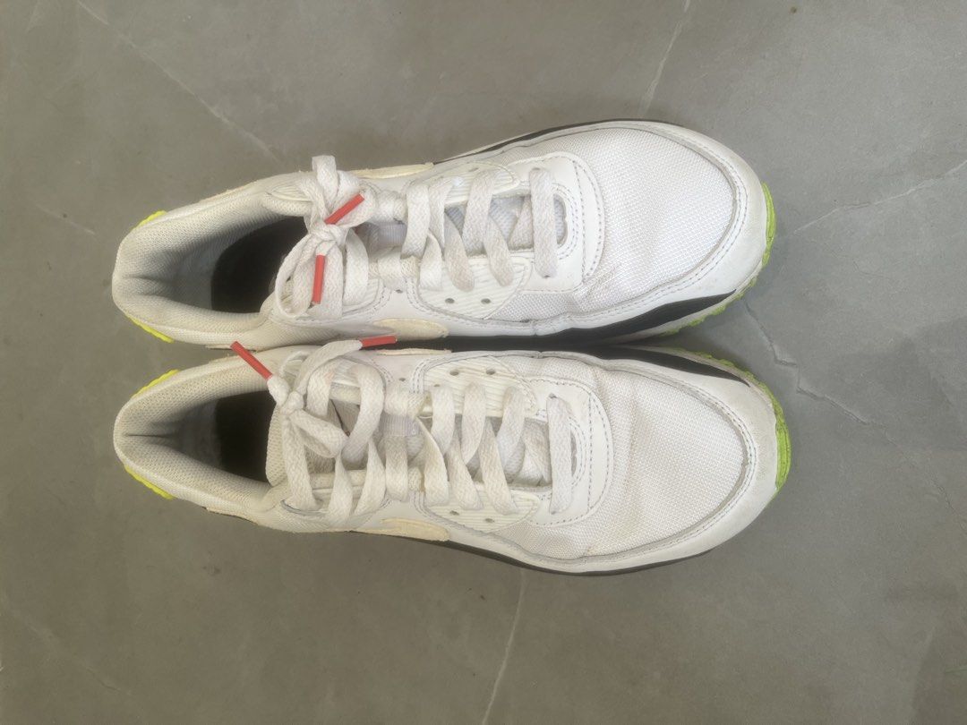 Nike Air Max 90 White Volt Pink (Category: Sneakers) located in Bulacan. Submitted by jhemieee (Listing ID 1470191401, Image 2). Description: - Brand/Model: Nike Air Max 90 - Colorway: White, black, pink, and bright yellow - Design: Classic retro runner with visible heel air unit - Materials: Mesh and leather upper construction - Condition: Uppers and laces are clean; soles and midsoles show normal wear, scuffing, and dirt from regular use.