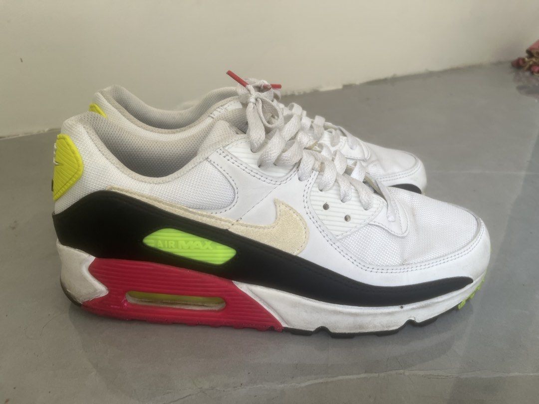 Nike Air Max 90 White Volt Pink (Category: Sneakers) located in Bulacan. Submitted by jhemieee (Listing ID 1470191401, Image 1). Description: - Brand/Model: Nike Air Max 90 - Colorway: White, black, pink, and bright yellow - Design: Classic retro runner with visible heel air unit - Materials: Mesh and leather upper construction - Condition: Uppers and laces are clean; soles and midsoles show normal wear, scuffing, and dirt from regular use.