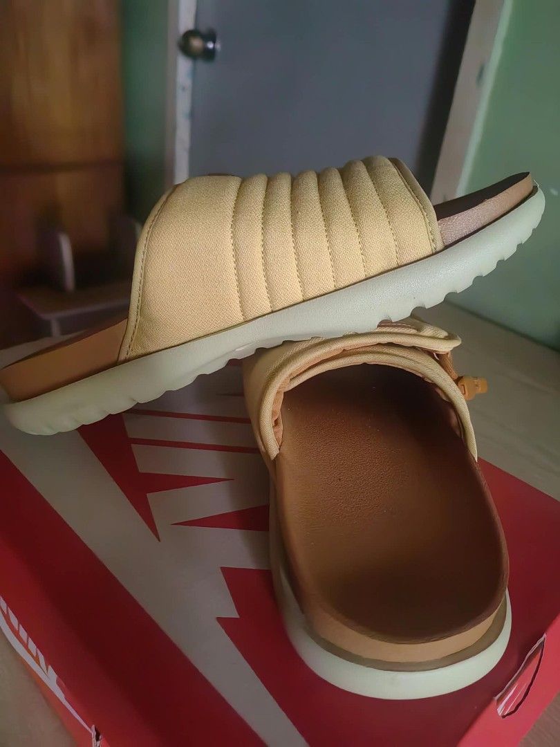 Nike Asuna 2 Slide Wheat Gold Size 9 (Category: Slippers & Slides) located in Manila. Submitted by judejose0203 (Listing ID 1470303379, Image 2). Description: - Brand: Nike - Model: Asuna 2 Slides - Colorway: Wheat Gold / Team Gold - Size: US 9 / UK 8 / EUR 42.5 - Condition: Brand new with original red Nike shoebox - Features: Padded strap with adjustable side toggle system and Nike Sportswear logo patch - Style: Super comfortable slip-on sandals