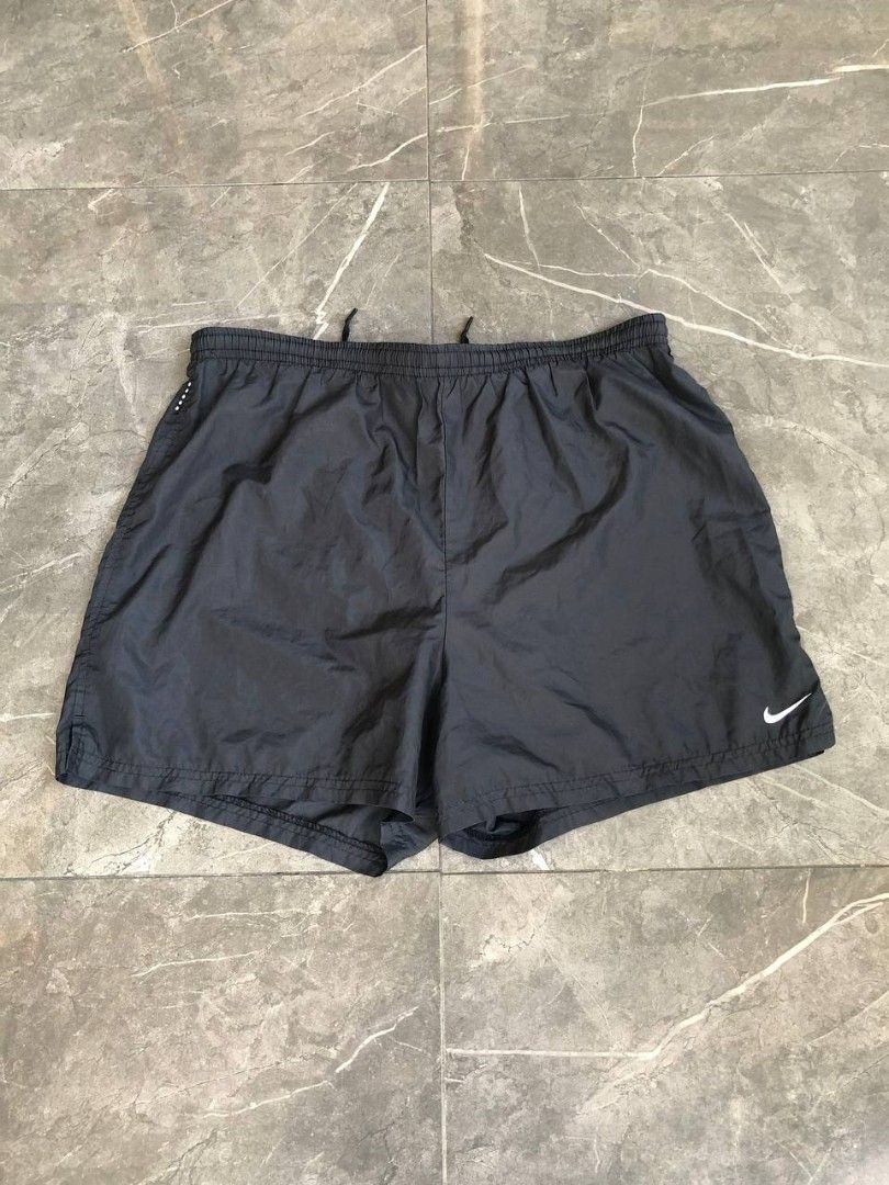 Nike Black Nylon Running Shorts Size M (Category: Shorts) located in Santa Cruz. Submitted by remsonnnc (Listing ID 1470216022, Image 1). Description: - Brand: Nike - Style: Vintage athletic running shorts (Made in Taiwan) - Size: Medium (Fit AU/US 8-10) - Color: Black with small white Nike Swoosh logo on lower left leg - Material: Lightweight nylon - Features: Elastic waistband with adjustable drawstring and built-in liner Waist: 34 Length: 15 H