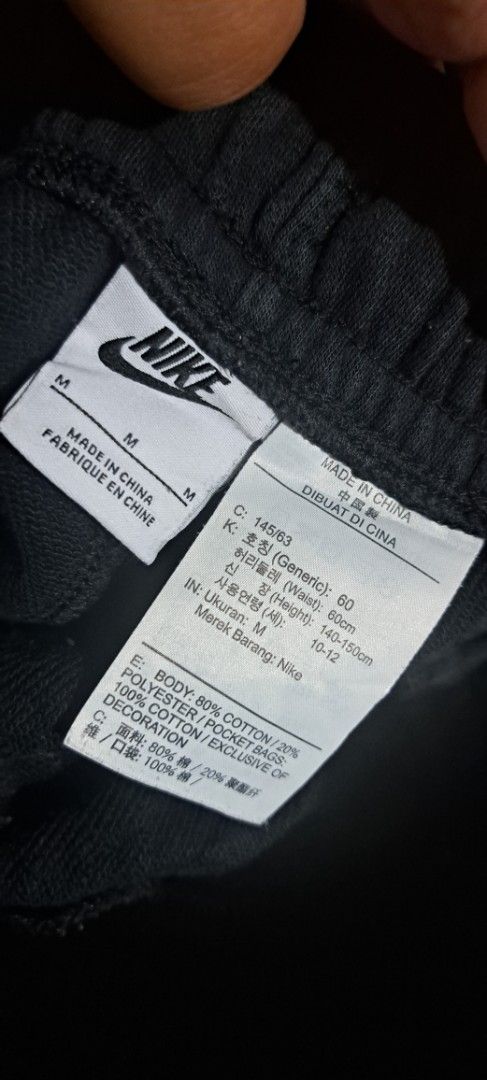 Nike Black Shorts Size M (Category: Shorts) located in San Fernando, Camarines Sur. Submitted by ladderaya (Listing ID 1470241437, Image 2). Description: - Brand: Nike - Color: Black - Size: Youth Medium (fits heights 140-150cm) - Design: Large grey & white Nike logo on left leg - Features: Adjustable drawstring waist with side pockets - Material: 80% cotton, 20% polyester blend - Style Code: CK0509-010 - Condition: Clean with tags attached.